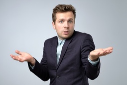thumbnail of Confused young caucasian man in suit shrugging his shoulders.jpg
