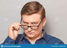 thumbnail of portrait-serious-man-looking-over-glasses-something-interesting-studio-close-up-blond-mature-his-scrutinising-skeptical-209099053.jpg