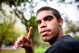 thumbnail of young-aboriginal-adult-outdoors-pointing-finger-austockphoto-000015396.jpg