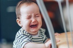 thumbnail of baby-girl-stands-crying-loudly-standing-near-chair-home-1024x683.jpg